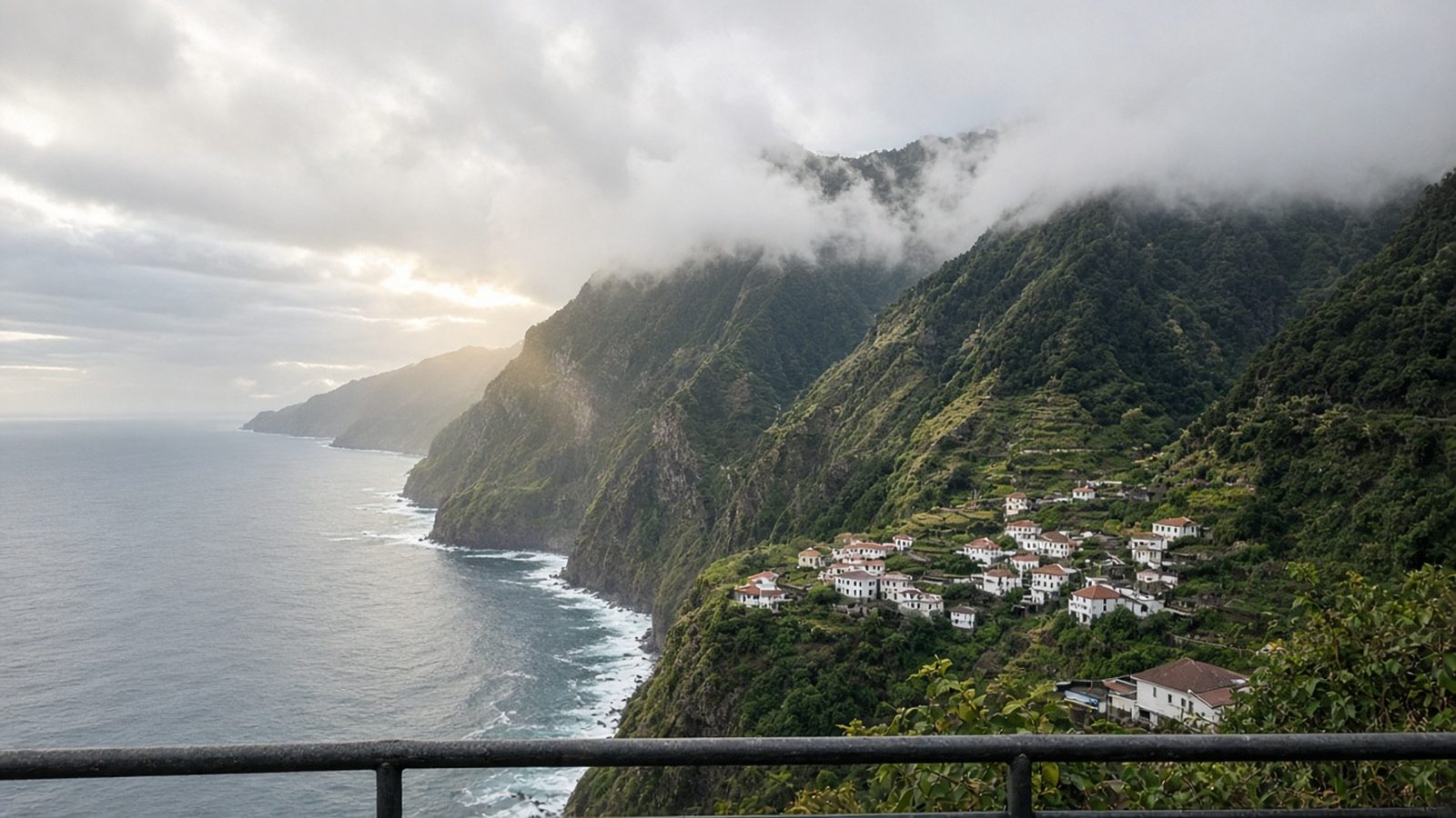 Steep green cliffs and terraces on Madeira's north coast above the Atlantic